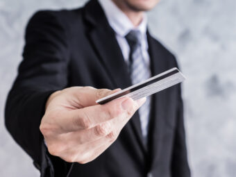 Close up of businessman holding credit card.